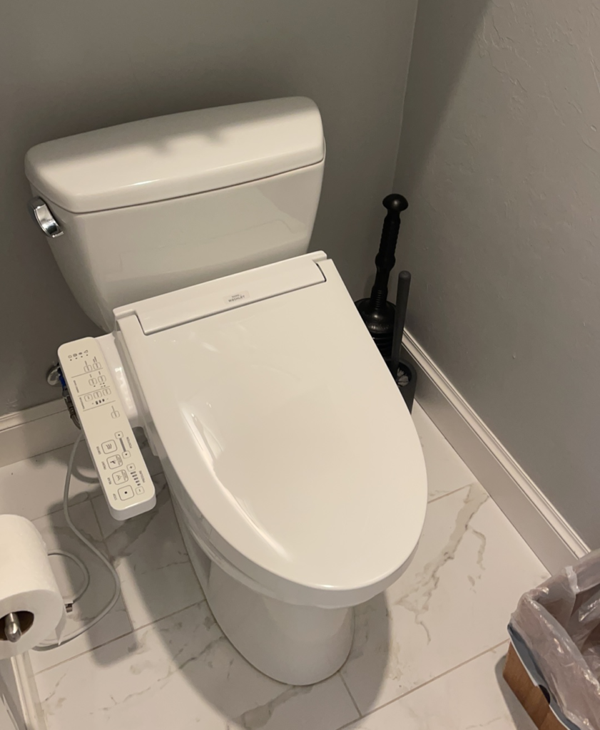 Finished and cleanly installed White Washlet bidet seat by Vintage Plumbing