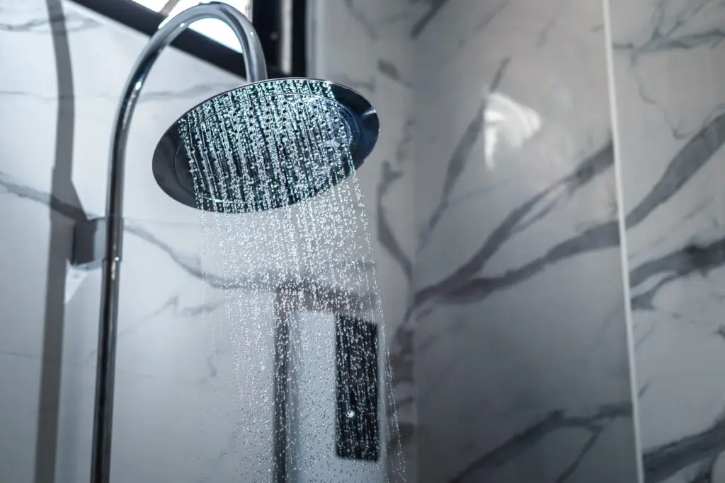 [shower head] shower head in bathroom with water drops flowing.