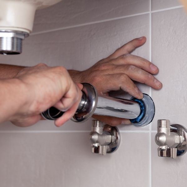 plumber working on pipes